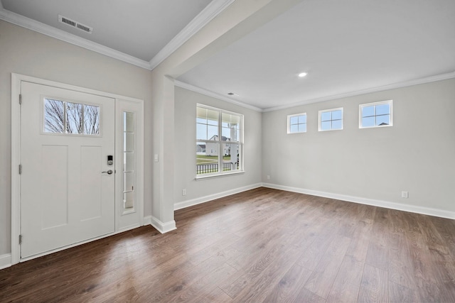 entryway featuring visible vents, wood finished floors, baseboards, and ornamental molding