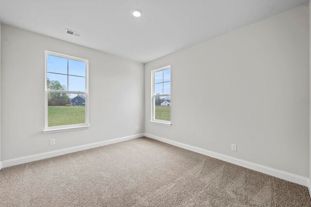 spare room featuring visible vents, recessed lighting, baseboards, and carpet floors