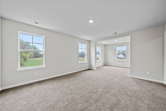 empty room with recessed lighting, carpet, visible vents, and baseboards