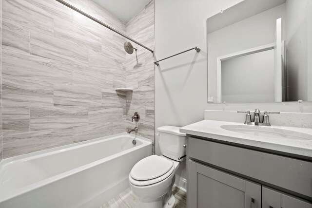 full bathroom featuring vanity, toilet, and washtub / shower combination