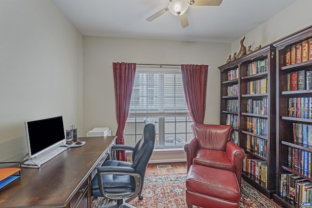 office area featuring a ceiling fan, wood finished floors, and visible vents