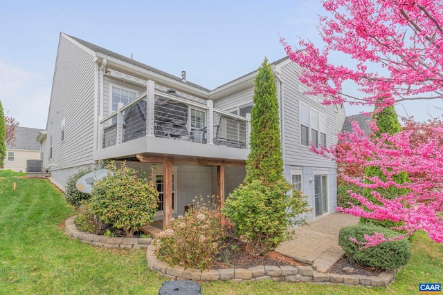 view of property exterior with central AC, a sunroom, a yard, and a patio