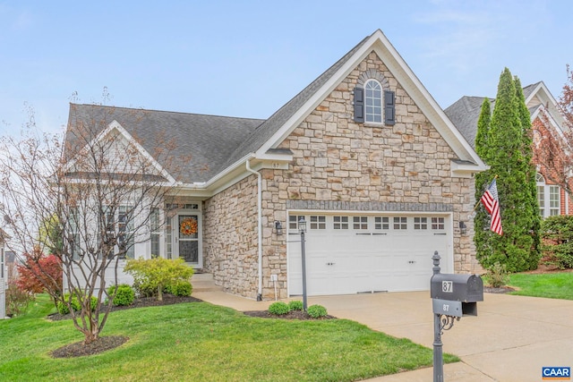 view of front facade with an attached garage, driveway, stone siding, roof with shingles, and a front yard