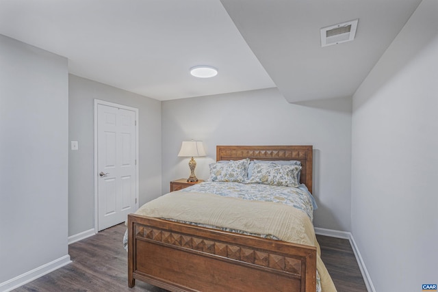 bedroom featuring visible vents, baseboards, and dark wood-style floors