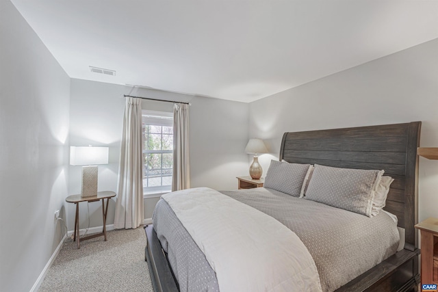 bedroom featuring light colored carpet, baseboards, and visible vents