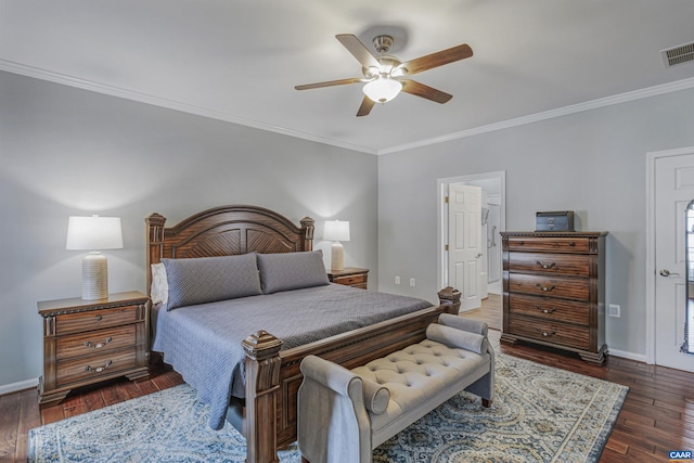 bedroom featuring wood finished floors, visible vents, a ceiling fan, crown molding, and baseboards