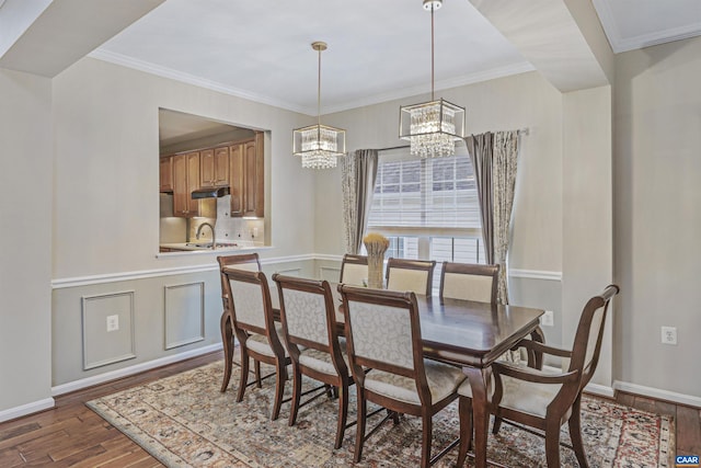 dining area with baseboards, ornamental molding, dark wood-style floors, and a notable chandelier