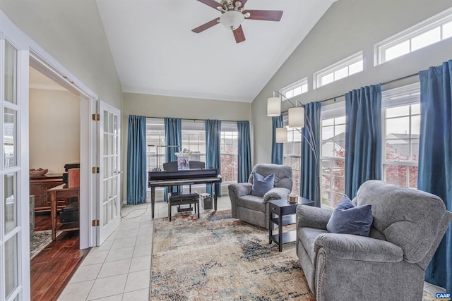 living area featuring a wealth of natural light, french doors, high vaulted ceiling, and a ceiling fan