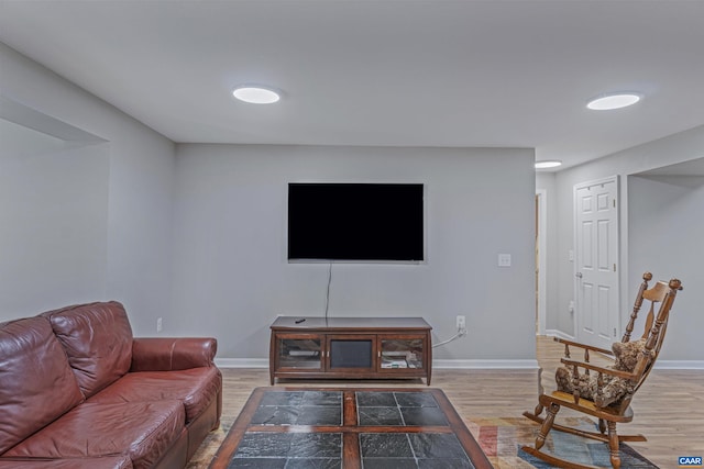 living area with wood finished floors and baseboards