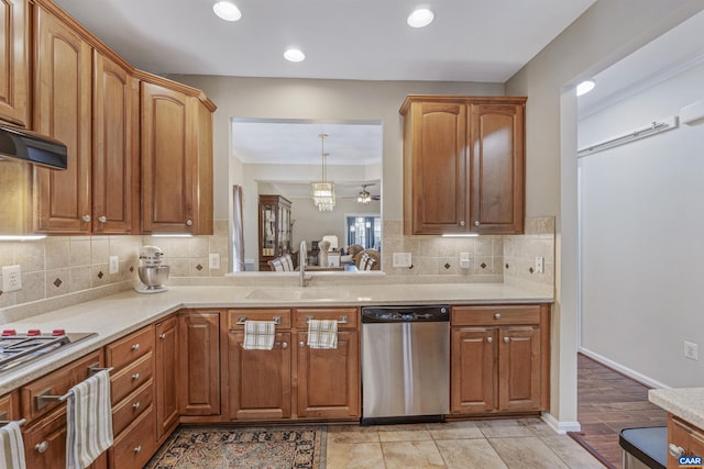 kitchen with tasteful backsplash, a sink, stainless steel appliances, light countertops, and recessed lighting