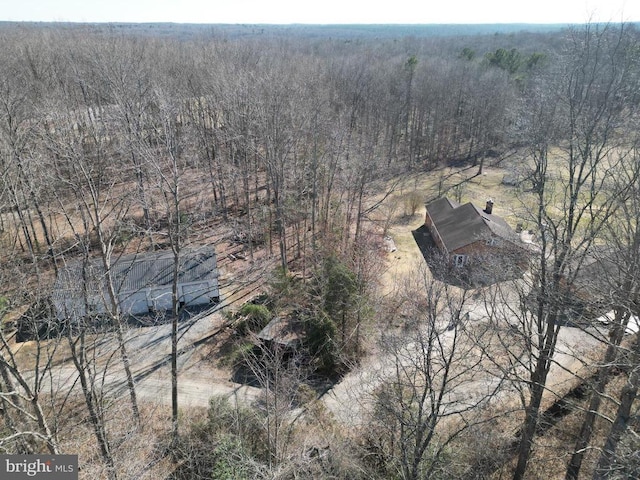 drone / aerial view featuring a forest view