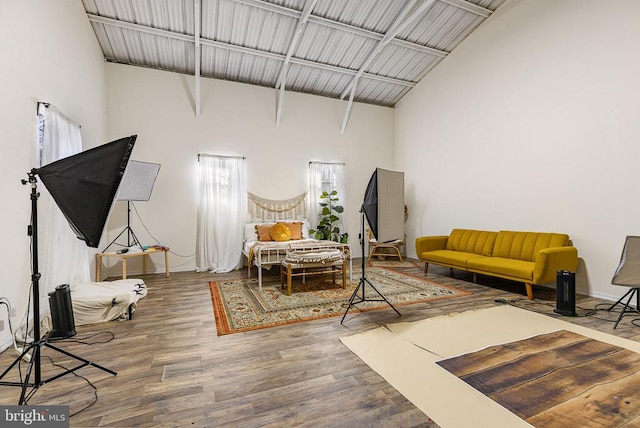 living room with a high ceiling, wood finished floors, and baseboards