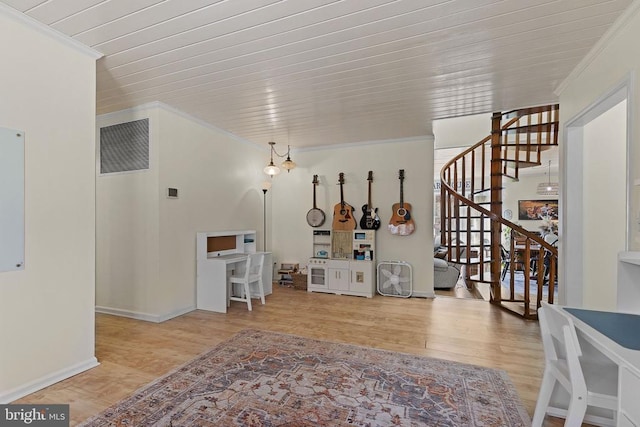 interior space with visible vents, baseboards, stairway, ornamental molding, and wood finished floors