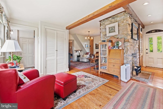 living room featuring wood-type flooring and a notable chandelier