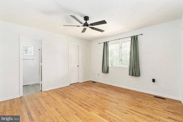 empty room featuring ceiling fan and light hardwood / wood-style floors