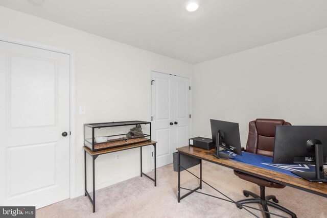 carpeted office space featuring baseboards