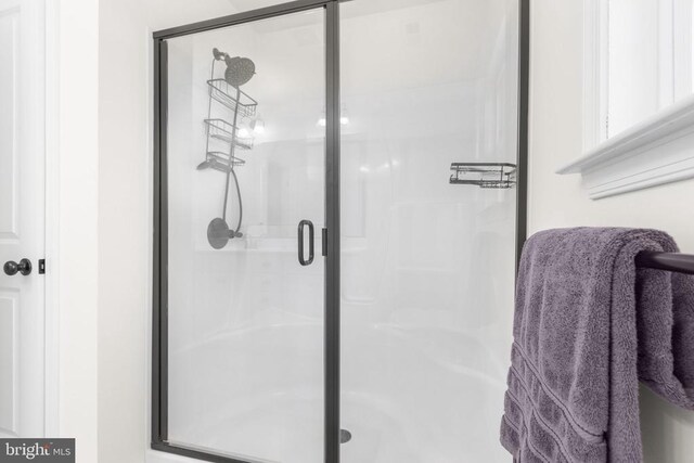full bath with a shower stall