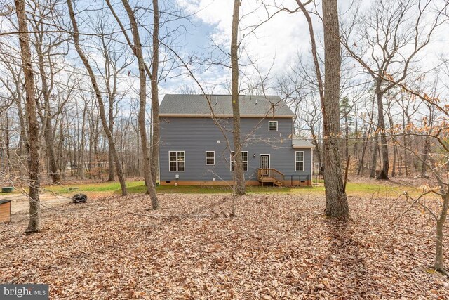 rear view of property with crawl space