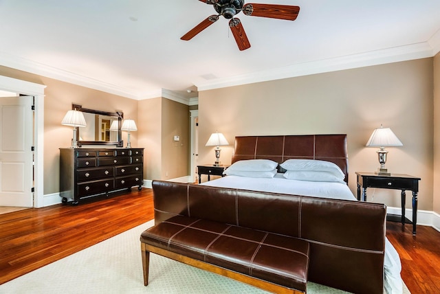 bedroom featuring crown molding, ceiling fan, and dark hardwood / wood-style flooring