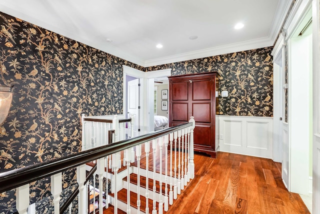 hallway featuring hardwood / wood-style flooring and ornamental molding