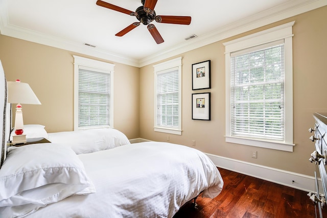 bedroom featuring dark hardwood / wood-style flooring, ornamental molding, and ceiling fan