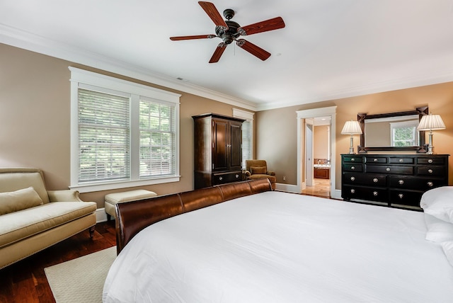 bedroom with crown molding, ensuite bath, dark hardwood / wood-style floors, and ceiling fan