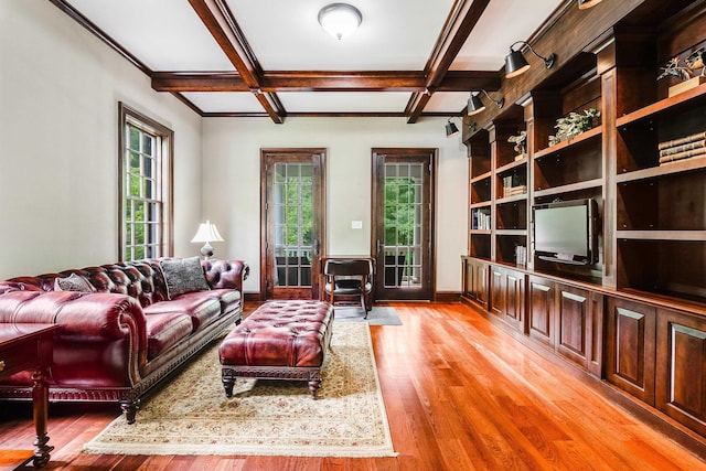 living room with coffered ceiling, beam ceiling, and light hardwood / wood-style floors