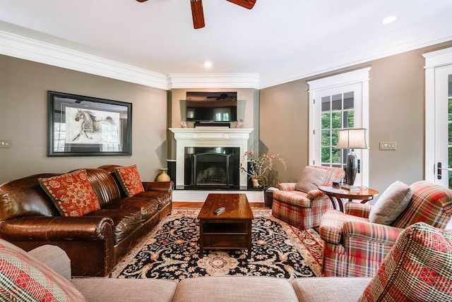 living room featuring crown molding and ceiling fan