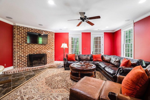 living room featuring crown molding, a fireplace, and ceiling fan