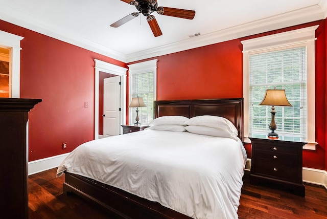 bedroom with dark hardwood / wood-style flooring, crown molding, and ceiling fan