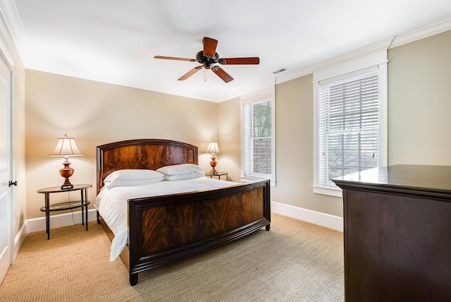 bedroom featuring crown molding, light colored carpet, and ceiling fan