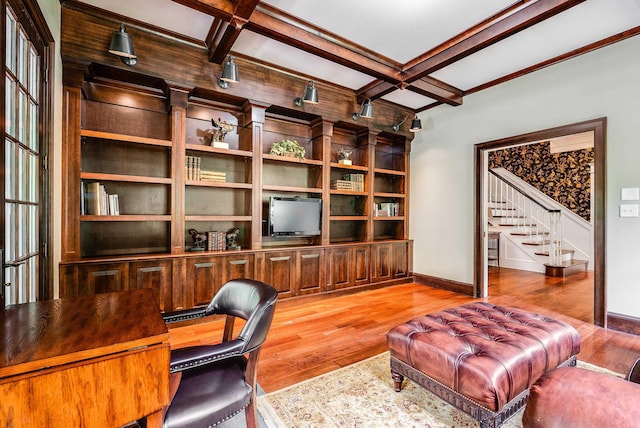 home office with beamed ceiling, coffered ceiling, and light wood-type flooring