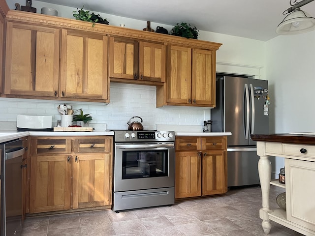 kitchen featuring stainless steel appliances and tasteful backsplash