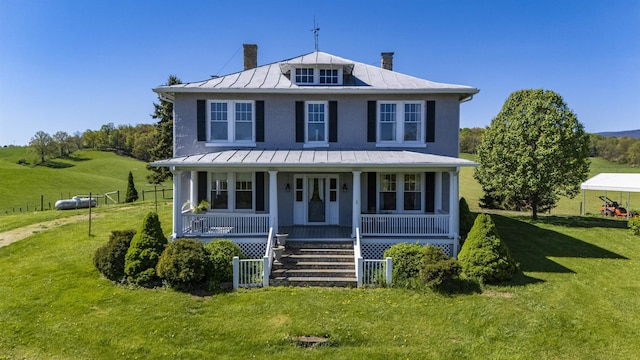 view of front of house with a front yard and covered porch