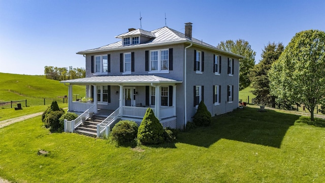 view of front of home with a front lawn and a porch