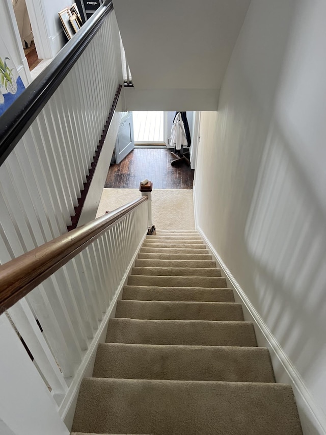 stairway featuring hardwood / wood-style floors