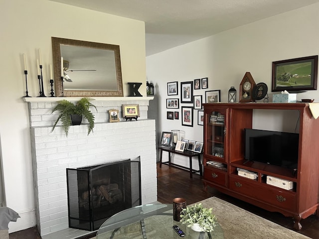 living room with dark hardwood / wood-style floors and a fireplace