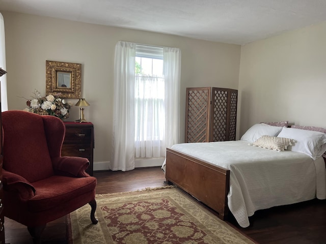 bedroom with dark hardwood / wood-style floors