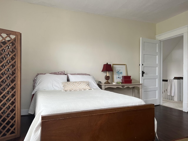 bedroom with dark hardwood / wood-style floors