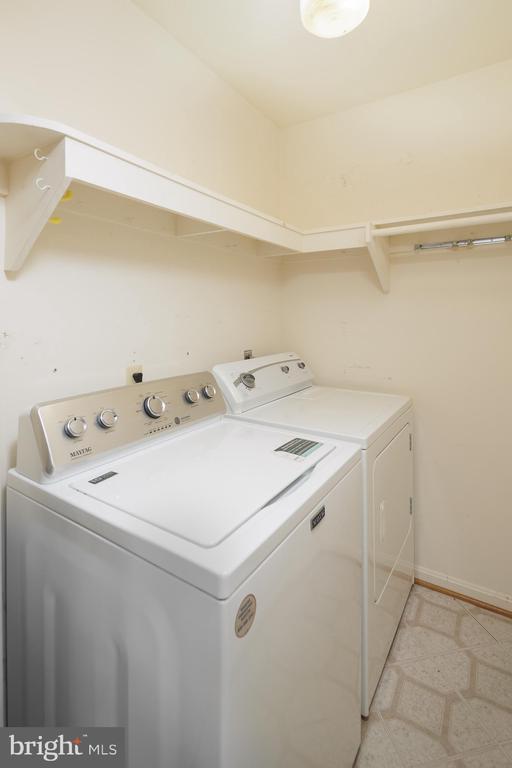 clothes washing area featuring independent washer and dryer