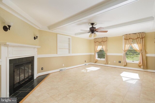 unfurnished living room featuring a tiled fireplace, ceiling fan, built in features, and beam ceiling