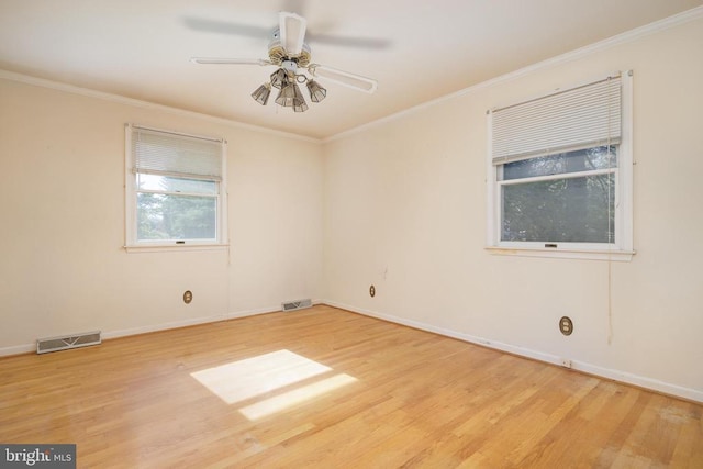 empty room with ornamental molding, ceiling fan, and light hardwood / wood-style floors