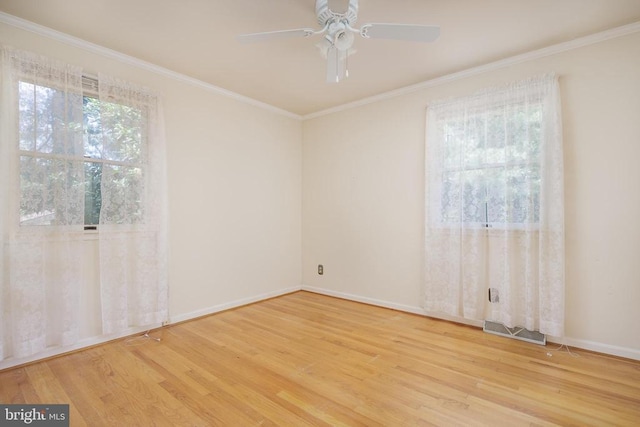 spare room featuring hardwood / wood-style flooring, crown molding, and ceiling fan