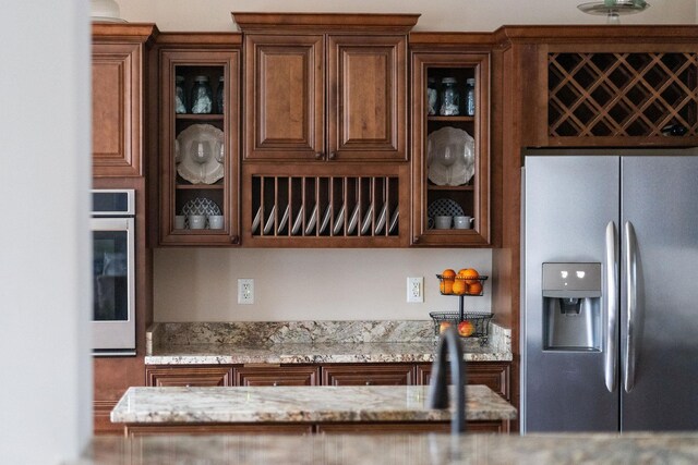 kitchen featuring light stone countertops and stainless steel appliances