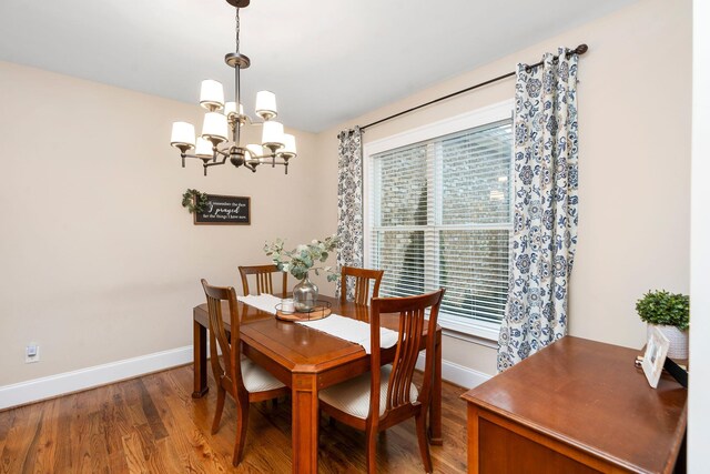 dining space with an inviting chandelier and wood-type flooring