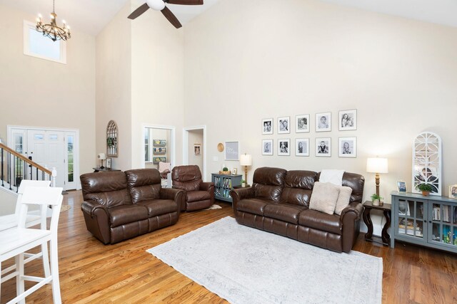 living room featuring wood-type flooring and ceiling fan with notable chandelier