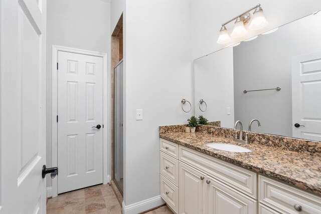 bathroom with vanity and a shower with door