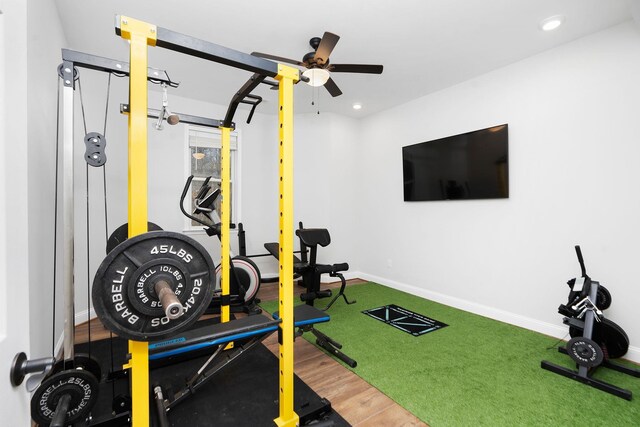 exercise room with hardwood / wood-style floors and ceiling fan