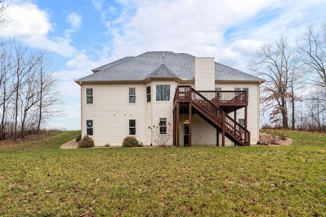 rear view of house with a wooden deck and a yard