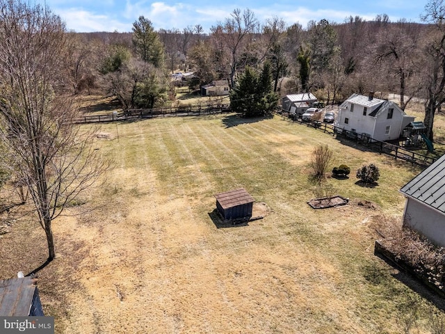 drone / aerial view with a wooded view and a rural view